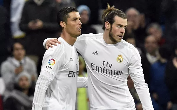 Real Madrid's Welsh forward Gareth Bale (R) celebrates a goal with Real Madrid's Portuguese forward Cristiano Ronaldo during the Spanish league football match Real Madrid CF vs RC Deportivo La Coruna at the Santiago Bernabeu stadium in Madrid on January 9, 2016. AFP PHOTO / GERARD JULIENGERARD JULIEN/AFP/Getty Images
