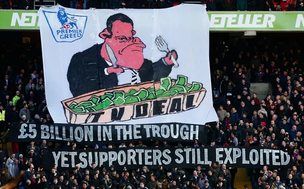 LONDON, ENGLAND - FEBRUARY 21: Fans display a banner in relation to the recent TV deal prior to the Barclays Premier League match between Crystal Palace and Arsenal at Selhurst Park on February 21, 2015 in London, England. (Photo by Clive Rose/Getty Images) 5£ billion in the trough yet supporters still exploited share the wealth,pigs